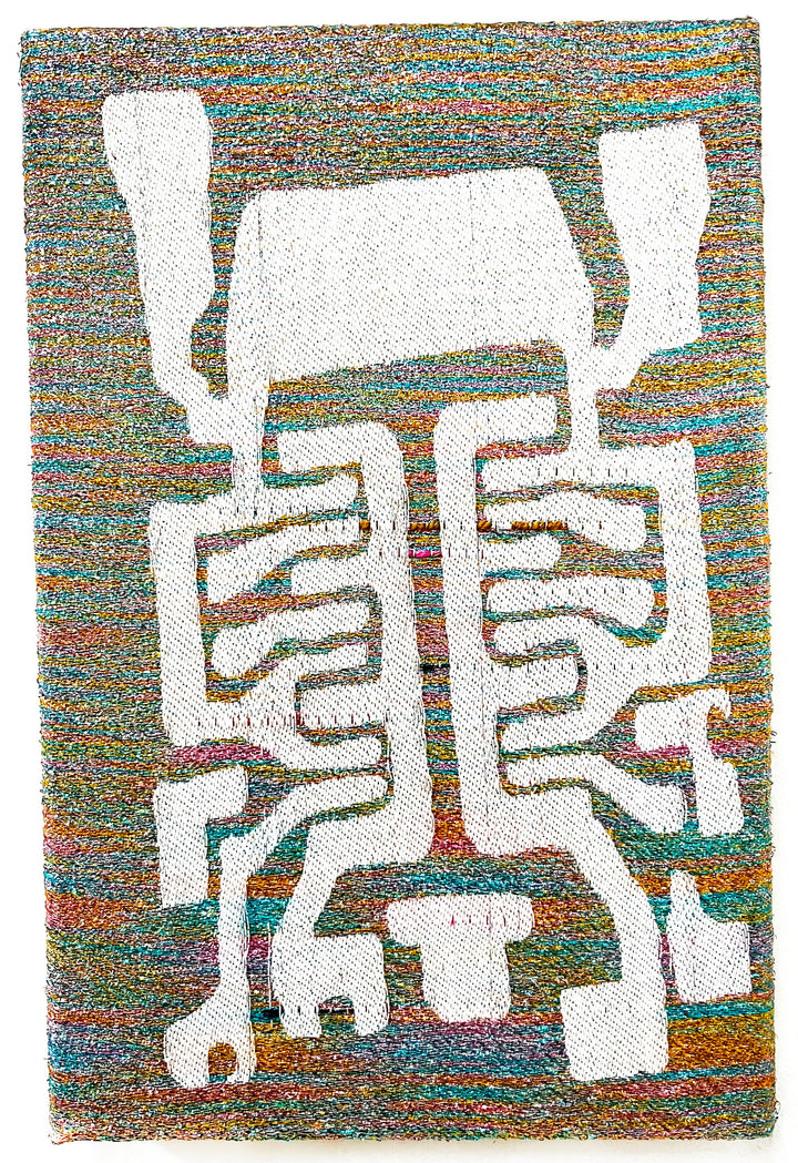 The artwork 'Spider Spirit' by Robin Kang features an abstract geometric white figure against a vibrant multicolored background. Handwoven with iridescent metallic yarn and cotton, the 13x8 inch piece displays intricate angular patterns resembling a stylized arachnid form. The background shimmers with interweaving threads of turquoise, orange, and rainbow hues, creating a dynamic textile composition by Robin Kang.