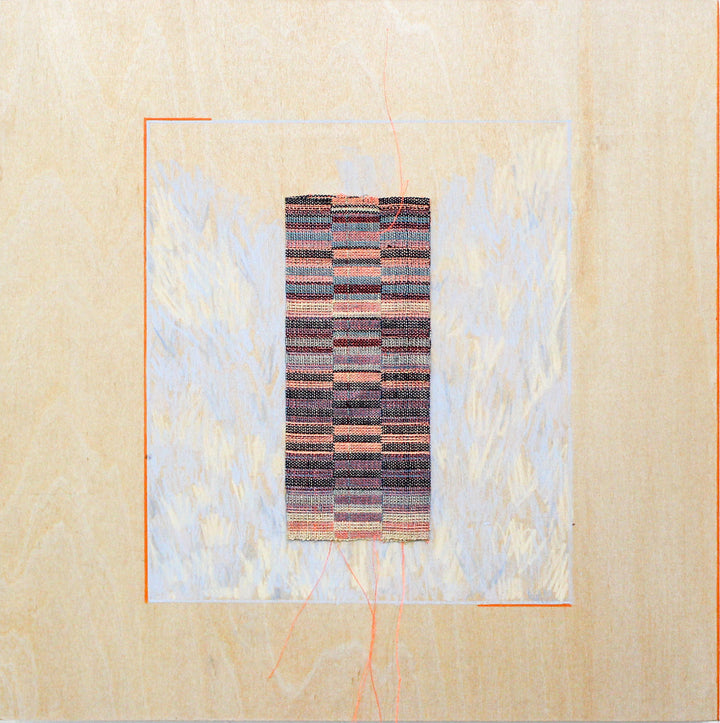 The artwork 'Reflector 2' by Molly Koehn features a vertical rectangular weaving in muted earth tones and metallic hues, centered on a cream-colored panel with ethereal blue brushstrokes. The handwoven piece combines stainless steel, linen, silk, and nylon in a geometric pattern, accented with subtle colored pencil marks, creating a striking contrast between industrial and natural materials.