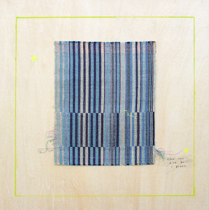 The artwork 'Reflector 4' by Molly Koehn features a geometric composition of vertical stripes in varying shades of blue and navy, handwoven with stainless steel, linen, silk, and nylon. The pattern creates a rhythmic effect with alternating stripe widths, set within a pale background and framed by a subtle yellow border.
